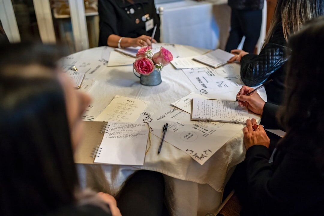 Small team of event organizers discussing plans around a table